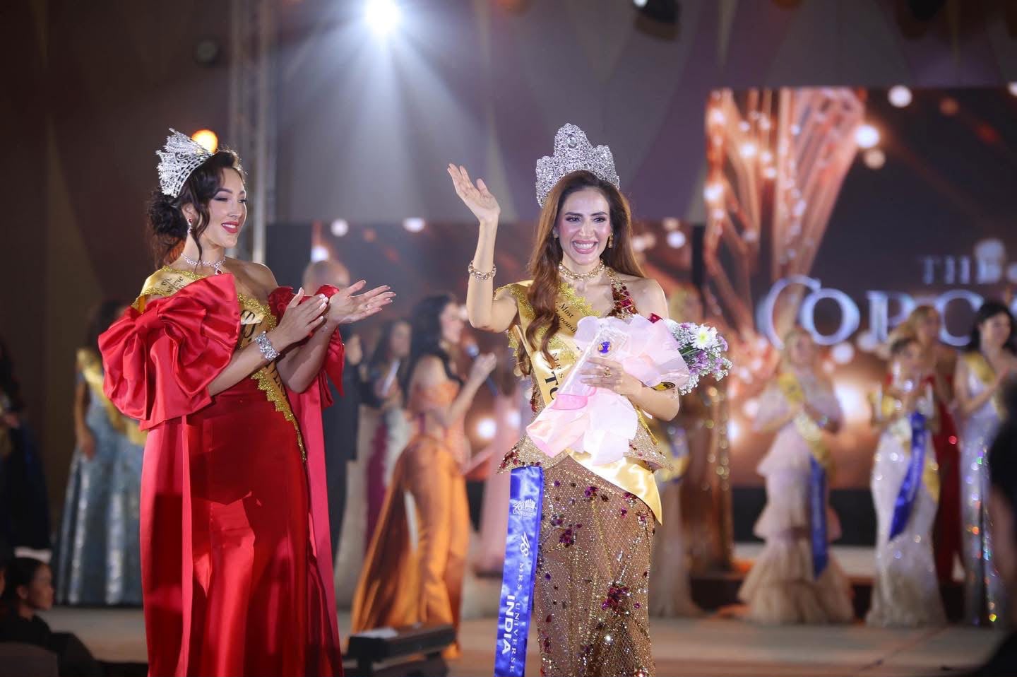 Mrs Universe 2025 on stage, crowned and waving to the audience